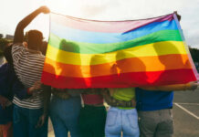 Budget-Busted Seattle Flirts With New ‘Emergency’ Group of people holding a rainbow flag during a pride celebration
