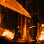 Firefighters battling a forest fire at night