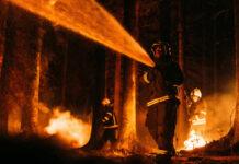 Firefighters battling a forest fire at night