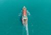 Mystery Oil Push Stuns Hormuz Aerial view of a cargo ship navigating through turquoise waters