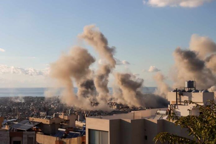 Beirut,,Lebanon,11,26,2024:,Smoke,From,Multiple,Israeli,Airstrikes Smoke rising from buildings in a city with a coastal view