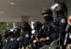 Independence Day Gets Security Overhaul Police officers in riot gear stand in a line