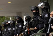Independence Day Gets Security Overhaul Police officers in riot gear stand in a line