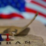New Iran Deal Sparks Trust Questions Map of Iran with push pins and a dollar bill in front of an American flag