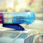 Close-up of a police cars light bar with blue and red lights