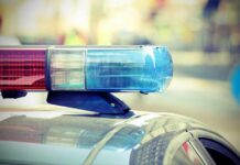 Close-up of a police cars light bar with blue and red lights
