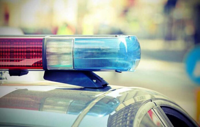 Close-up of a police cars light bar with blue and red lights