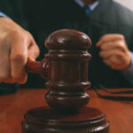 John Bolton Pleads Guilty In Secrets Case A judge striking a gavel on a wooden desk