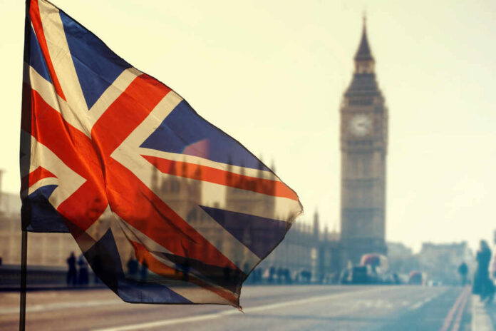 Uk,Flag,With,Big,Ben,And,House,Of,Parliament,In Union Jack flag waving in front of Big Ben in London
