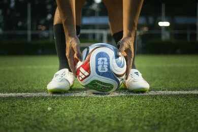 2692576267 Soccer player placing a ball on a field