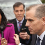 A journalist interviewing a political figure outdoors