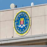 DOJ Battles Maryland Over College Benefits FBI emblem on a beige building facade