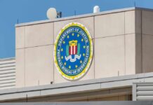 DOJ Battles Maryland Over College Benefits FBI emblem on a beige building facade