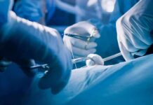 Doctors Urge Delaying Teen Gender Surgeries Surgeons' gloved hands performing an operation