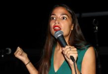 AOC Targets Senate, Raises Eyebrows Again Woman speaking into a microphone on stage