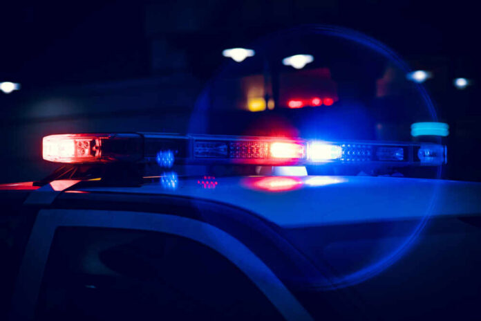 Close-up of police car lights flashing at night