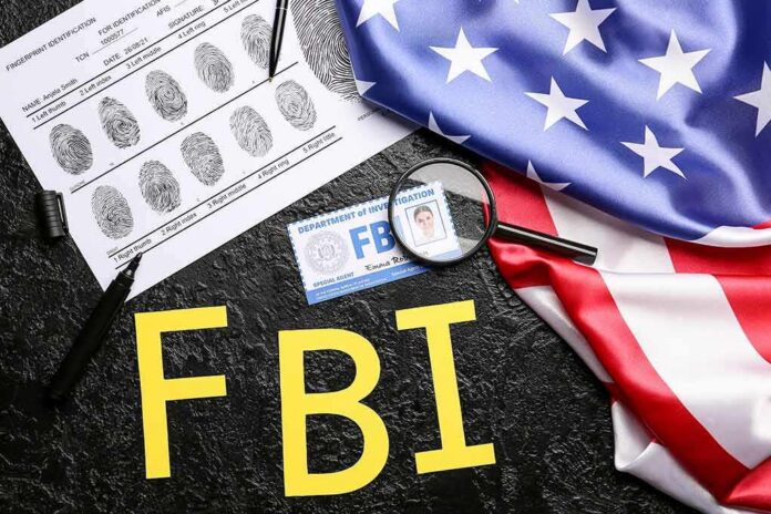 shutterstock_2202034347 FBI letters with fingerprint sheet, badge, magnifying glass, and US flag