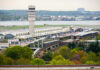 Florida Approves Trump Airport Rename View of an airport terminal with a control tower and surrounding greenery