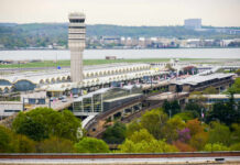 Florida Approves Trump Airport Rename View of an airport terminal with a control tower and surrounding greenery