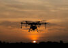 Cuba’s Drone Build-Up Raises Alarms A drone flying against a sunset sky, silhouetted by the evening light