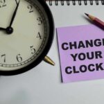 Daylight Saving Bill Advances In Congress Alarm clock and note on a desk