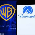 Logos of Warner Bros and Paramount Plus displayed on a screen