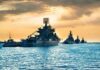 U.S. Intercepts Tanker Near Iranian Waters Naval warships anchored in a harbor at sunset