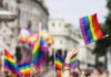 Why Does Seattle Need Emergency Powers? Crowd holding rainbow flags at a Pride parade