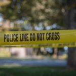 Back-To-Back Bodies Rattle Monterey yellow police tape cordoning off an outdoor area