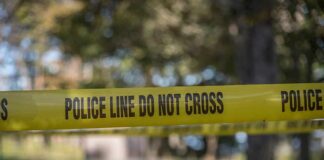 yellow police tape cordoning off an outdoor area