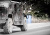 Drone Swarms Meet Electric Doom Military vehicle driving on a rural road
