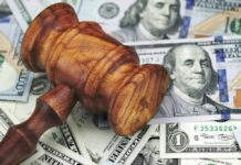 Wooden judge's gavel on scattered US dollar bills