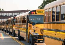 School Trip Sparks Religion Uproar Row of yellow school buses parked outside a brick school