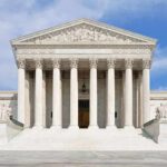 Supreme Court Faces Unusual Discipline Request Front view of the Supreme Court building with large columns and steps under a blue sky
