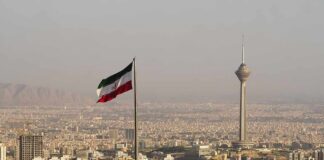 Iranian flag over Tehran skyline with Milad Tower