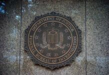 FBI Uncovers Green Card Playbook FBI seal on a granite wall