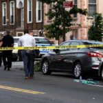 Data Drop Rattles Crime Narratives Police at urban street crime scene with yellow tape around parked cars
