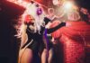 Florida Scores Victory In Drag Battle Drag performer singing on stage with dramatic lighting