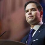 Rubio: Trump Won’t Back Down man in suit speaking at podium