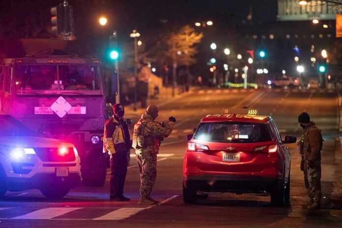 shutterstock_1897365067 Security officers stop a red taxi at a night checkpoint
