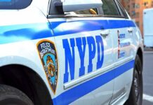 NYPD Scrambles After Shocking Tower Climb NYPD police car side with blue stripes and emblem