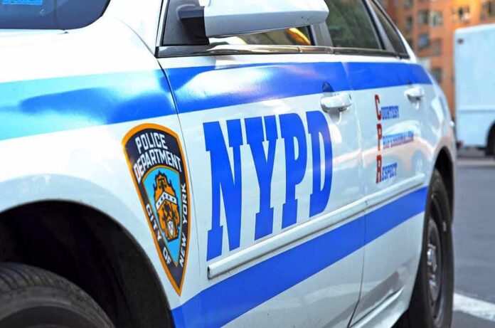 NYPD police car side with blue stripes and emblem