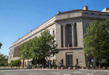 Neoclassical government building with columns and flag
