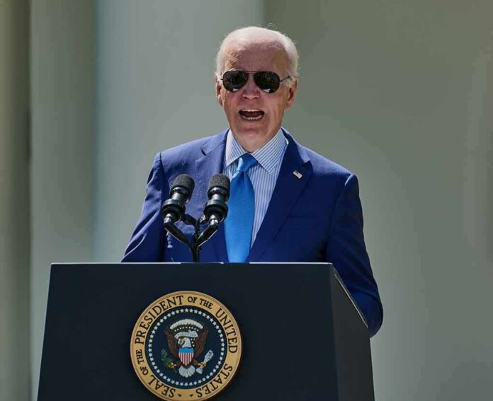 man in blue suit speaking at a podium with presidential seal