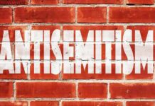 Brick wall with large white stencil text