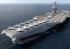 Aircraft carrier at sea with fighter jets on deck