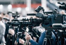 Governor Stunningly Dethroned — By His Own Party Broadcast cameras on tripods at a press event