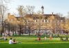 Two Deaths, One Mystery: Campus On Edge Students relaxing on a campus quad in front of a brick academic building