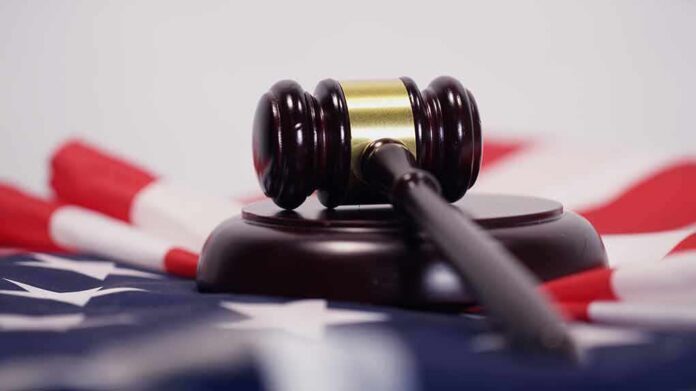 Judge’s gavel on a base over an American flag