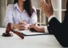 Two people in a legal consultation at a desk